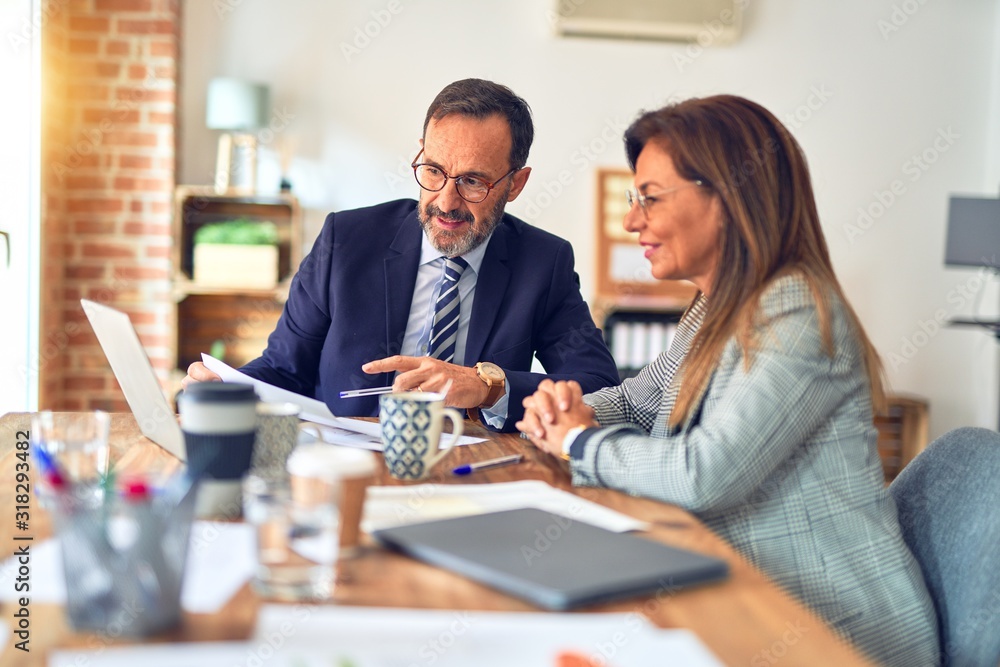 man and woman working together at desk